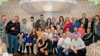 Darya Lazareva and her family pose holding up fake moustaches
