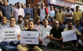 Kashmiri media persons hold placard during a stage a sit-in protest at Press Enclave in Srinagar summer capital of Indian Kashmir, 16 July 2016.