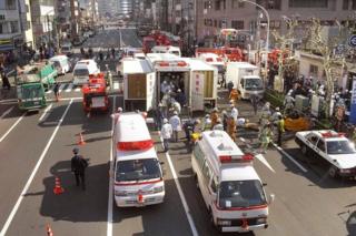 Rescue workers carry the survivors to the emergency rescue tents at Tokyo Metro Tsukiji Station on March 20, 1995 in Tokyo.