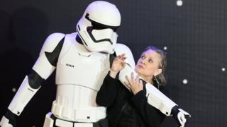 Carrie Fisher poses for cameras as she arrives at the European Premiere of 