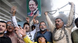 Supporters of Nawaz Sharif shout slogans a day after he was sentenced to 10 years in prison