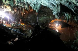Thai officials work to reduce the water level in a cave complex at the Tham Luang cave