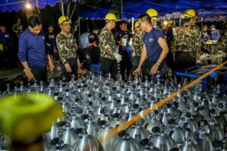 Scuba tanks are delivered to the rescue operation site for the Thai navy