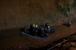 Soldiers and rescue workers work in Tham Luang cave complex