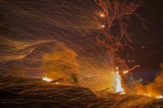A strong wind blows embers at the Thomas Fire in December 2017 in Montecito, California
