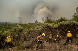 Firefighters from the Big Bear Hotshots create a firebreak as the Ferguson fire approaches in the Stanislaus National Forest, near Yosemite National Park, California, on 21 July 2018