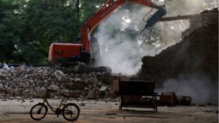 An excavator demolishes Chinese artist Ai Weiwei's art studio in northeastern Beijing, 4 August 2018