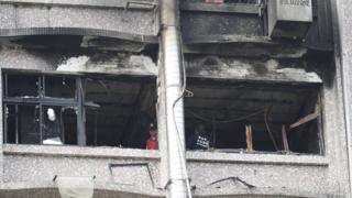 Fire inspectors view damages after a fire broke out at the Taipei Hospital in Hsinchuang, New Taipei City, Taiwan, 13 August 2018