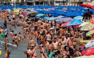 People cool off at the beach during the heatwave in the southeastern coastal town of Benidorm