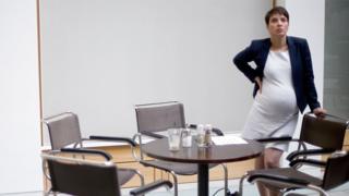 Frauke Petry, pregnant, at a table surrounded by chairs