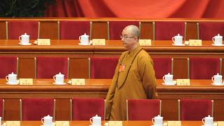 Buddhist Master Xuecheng arrives at the opening session of the Chinese People's Political Consultative Conference , 2014