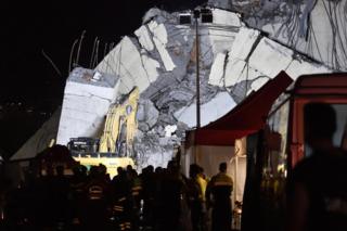Rescuers work into the night at the site of the Morandi viaduct upon which the A10 motorway runs that collapsed in Genoa, Italy, 14 August 2018