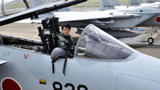 First Lieutenant Misa Matsushima of the Japan Air Self Defence Force poses in the cockpit of an F-15J air superiority fighter