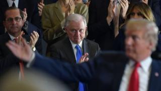 US Attorney General Jeff Sessions (centre) applauds Donald Trump (file photo)