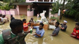 Volunteers distribute flood relief materials to residents at Pandanad in Chengannur on August 19, 2018 in Alapuzha, India