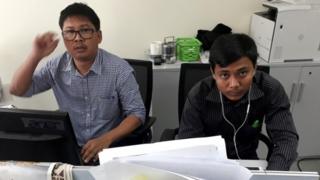 Wa Lone (L) and Kyaw Soe Oo at a desk in the Reuters office in Yangon