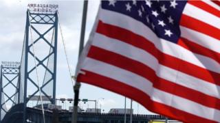 Trucks head to US customs after crossing the Ambassador Bridge that connects Detroit, Michigan, and Windsor, Ontario, Canada, 28 September 2001.