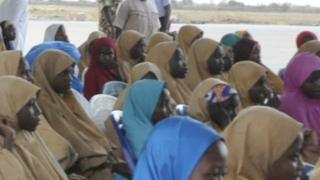 The freed 104 Dapchi girls, one other girl and a boy assembled at the Nigerian Air Force Base in Maidugurion.