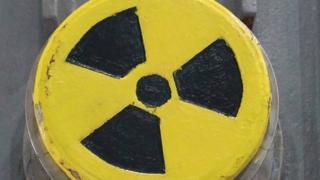A symbol for radioactivity on a radioactively-contaminated container once used to transport nuclear fuel rods