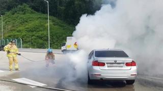Firemen put out a burning BMW in Uiwang, Gyeonggi Province, South Korea (9 Aug 2018)