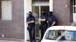 Police guard the home of an alleged attacker in Cornellà de Llobregat