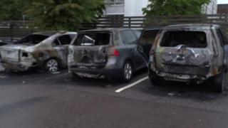 Burned cars are seen in a row in Gothenburg, Sweden