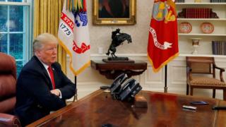 U.S. President Donald Trump answers a reporter's question during an interview with Reuters in the Oval Office of the White House in Washington