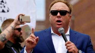 Alex Jones speaking outside of a Trump campaign event