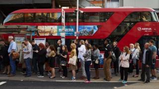 Commuters wait for London bus