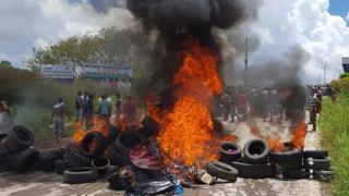 Residents of Pacaraima burn tyres and belongings of Venezuelans immigrants after attacking their makeshift camp on August 18, 2018