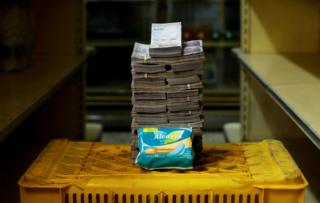 A packet of sanitary pads next to 3,500,000 bolivars