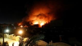Flames emerge from the Governorate Council building in Basra