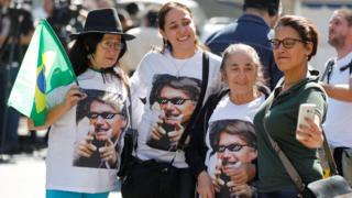 Supporters of Jair Bolsonaro gathered in front of Albert Einstein hospital in Sao Paolo, wearing t-shirts with his face printed on it