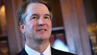 Brett Kavanaugh smiles during an appearance on Capitol Hill.