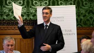 Jacob Rees-Mogg holding the report