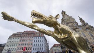 A wolf sculpture by artist Rainer Opolka making a Nazi salute is pictured in Dresden, 15 March 2016