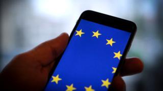 A smartphone with the flag of the European Union on its screen