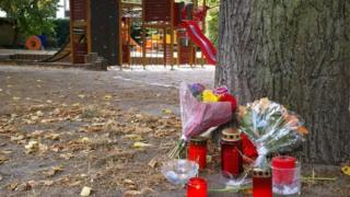 Candles and flowers displayed at a playground after the killing of a 22-year-old German man in a fight in Koethen.