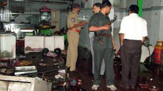 Police inspect the interior after the blast at Gokul Chat in Hyderabad