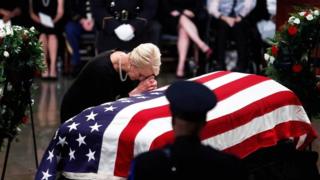 Cindy McCain leans over his casket as his body lies in state inside the US Capitol in Washington on 31 August 2018