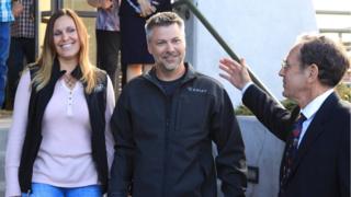 Josh and his wife Kelli walking out of the courthouse this morning, with Steve Wax