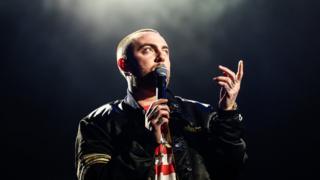 Mac Miller on stage pointing upwards in Los Angeles in 2017