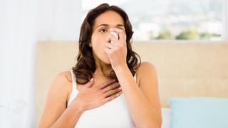 Woman using an inhaler