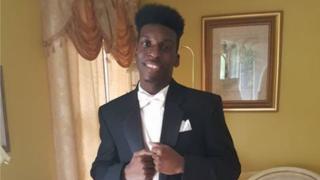 Photo of Emantic Bradford Jr in a tuxedo at his father's home