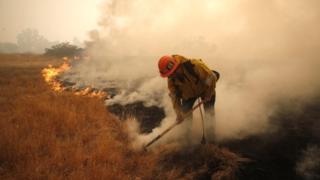 Firefighter tackles a fire in California