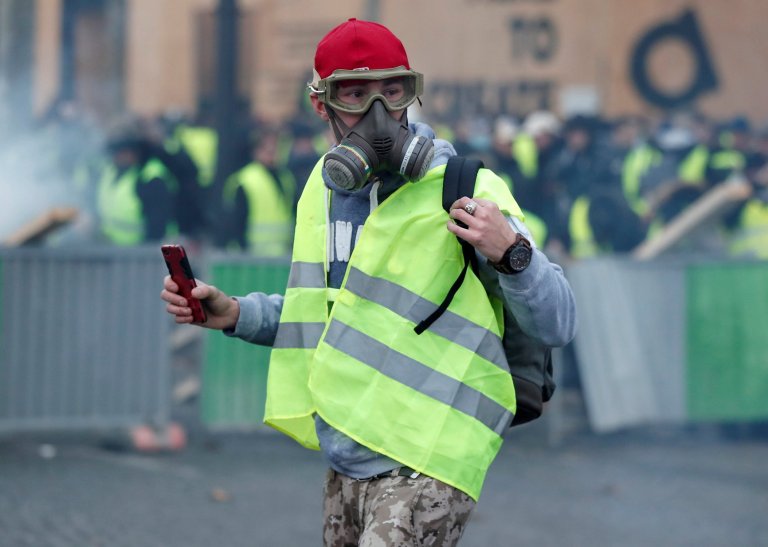 A protester wearing yellow vest, a symbol of a French drivers' protest against higher fuel prices, demonstrates on the the Champs-Elysee in Paris, France, November 24, 2018. REUTERS/Benoit Tessier