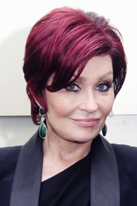 Sharon Osbourne rarely strays from her cherry red crop. Ensuring her hair falls just next to her eyes subtly draws attention to her cheekbones.