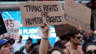 People protest President Trump's announcement of plans to reinstate a ban on transgender individuals from serving