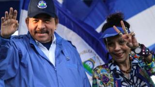 Nicaraguan President Daniel Ortega with his wife, Vice-President Rosario Murillo, gesture at supporters during a rally in Managua, 5 September 2018