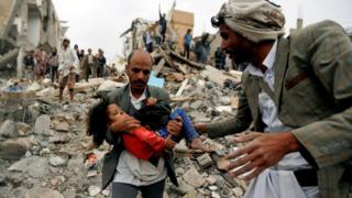 A man carries Buthaina Muhammad Mansour, believed to be four or five, rescued from the site of a Saudi-led air strike that killed eight of her family members in Sanaa, Yemen August 25, 2017.